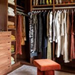 Walk-in closet with wood shelving, hanging rods, shoe shelves and drawers